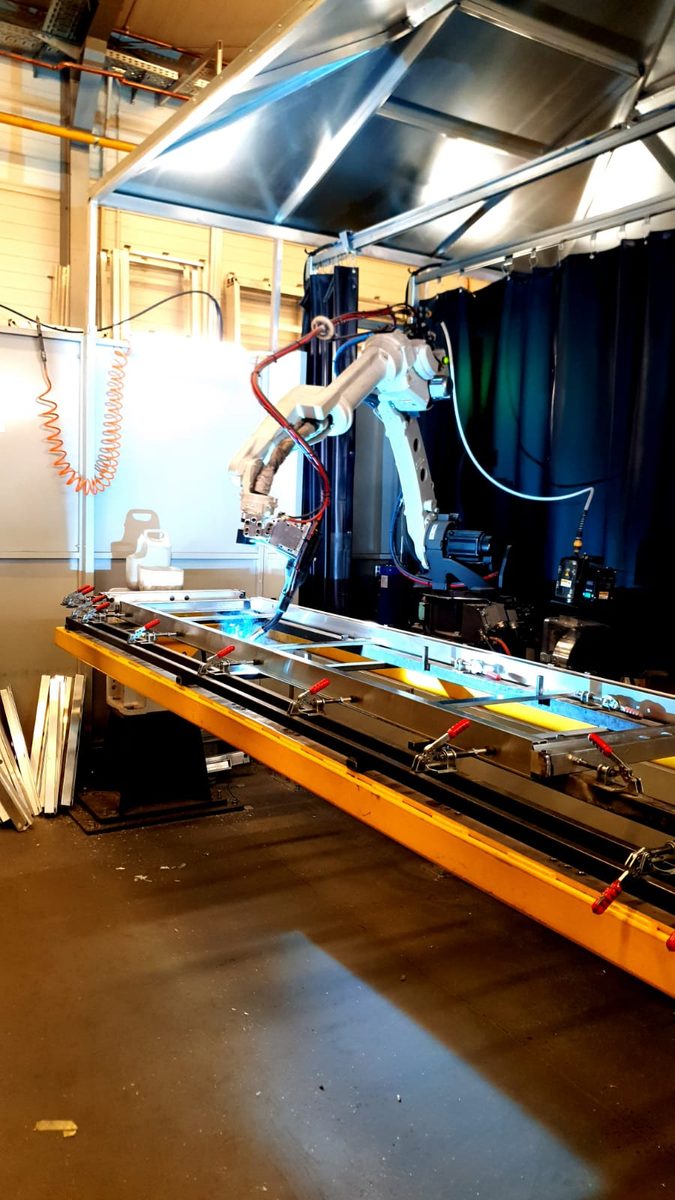 Robot spawalniczy spawa aluminiową ramę w zakładzie Art-Tech